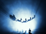 Kerstkaart: De Kerstman vliegt met zijn arrenslee en zijn rendieren door de lucht