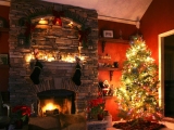 Kerstkaart: Rijk versierde kerstboom staat naast de brandende open haard